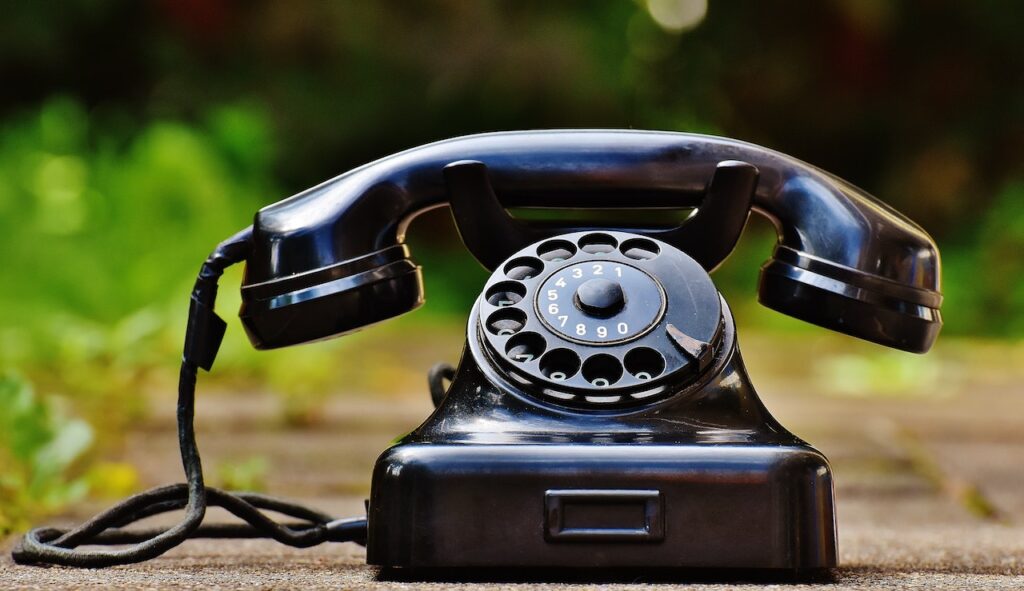 Image of rotary phone on ground outdoors