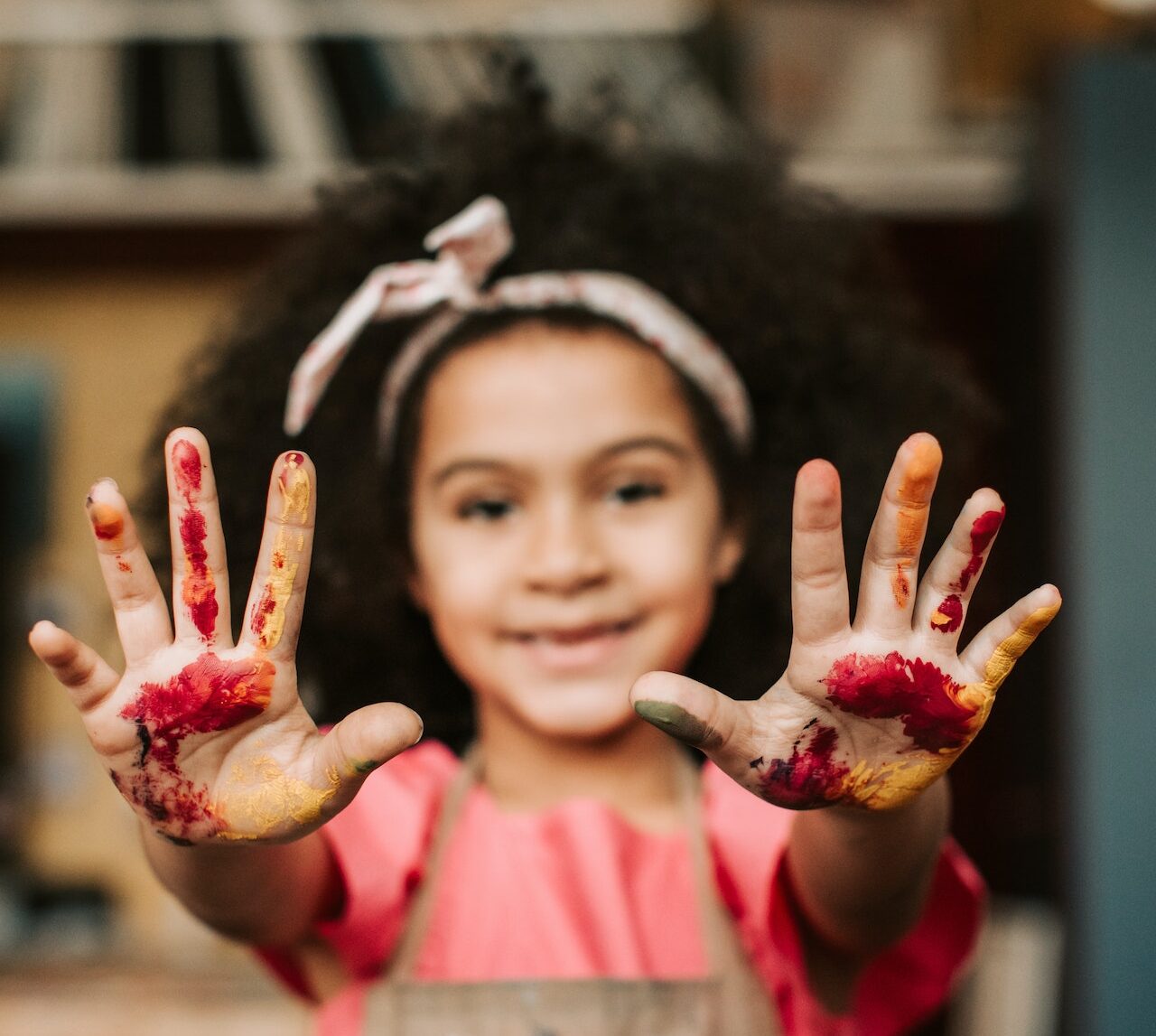 Image of girl with paint on both hands
