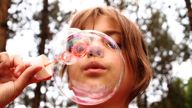 Image of child blowing bubble